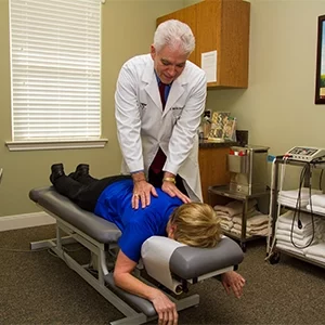 Chiropractor Dickinson TX Charles Wayne Browne Adjusting Patient